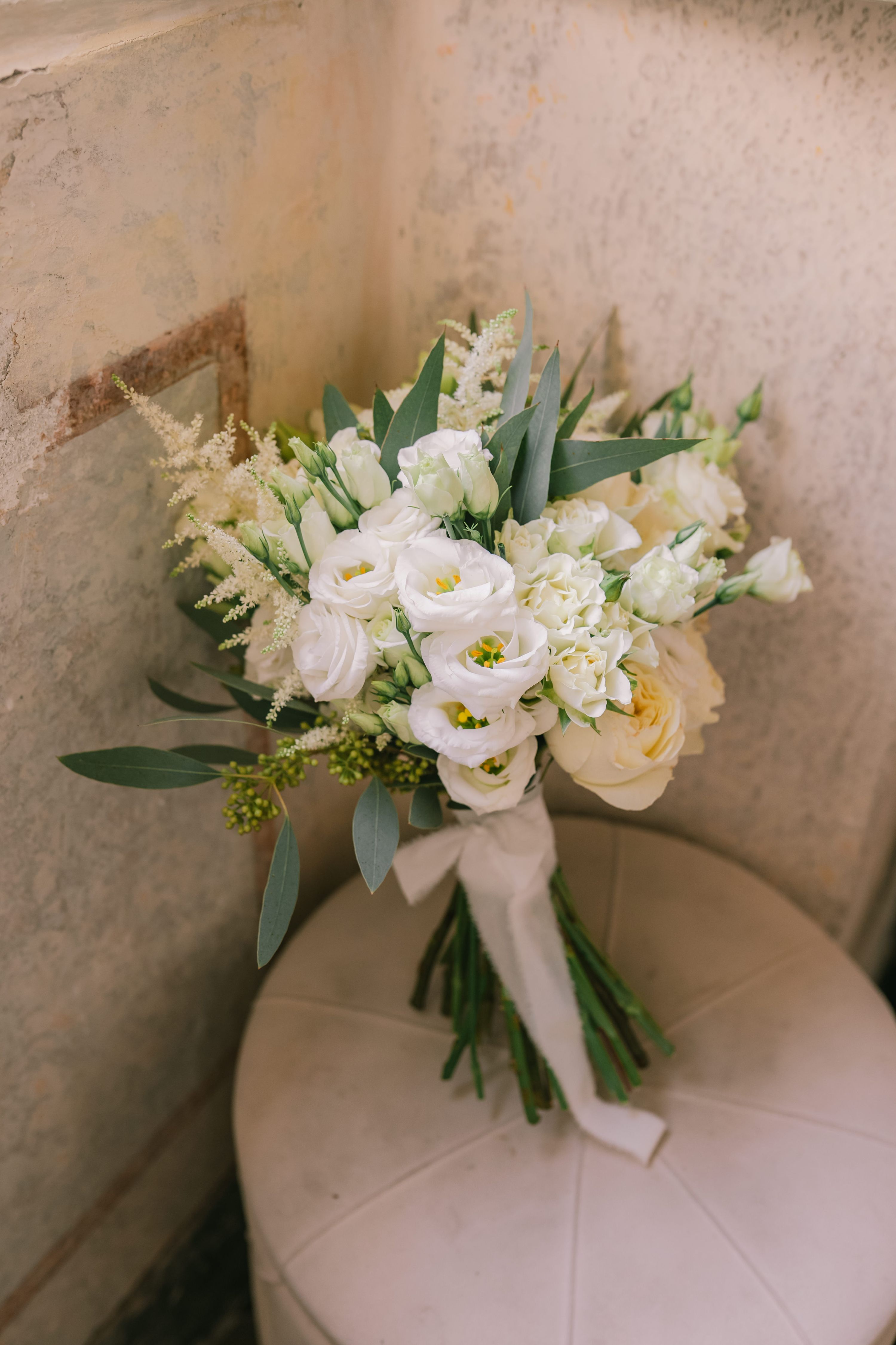 White roses and filler flowers plus minty green leaves for a vow renewal in Italy