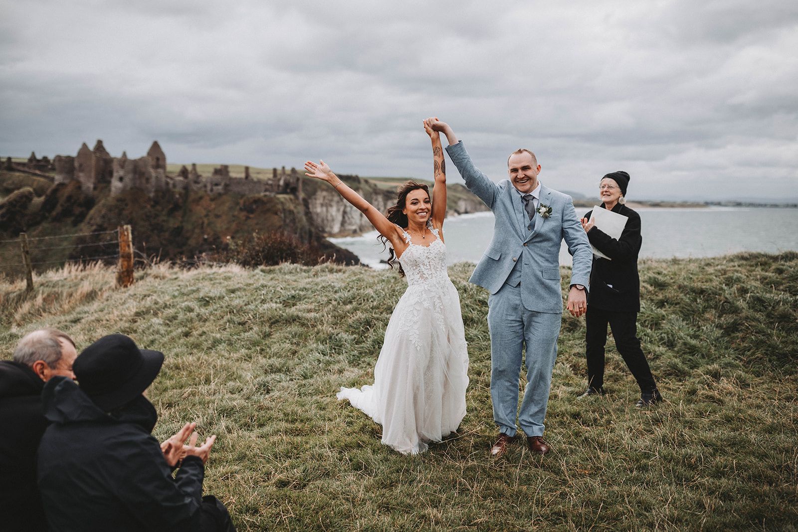 Happy newlyweds on top of a cliff after the wedding ceremony in Northern Ireland