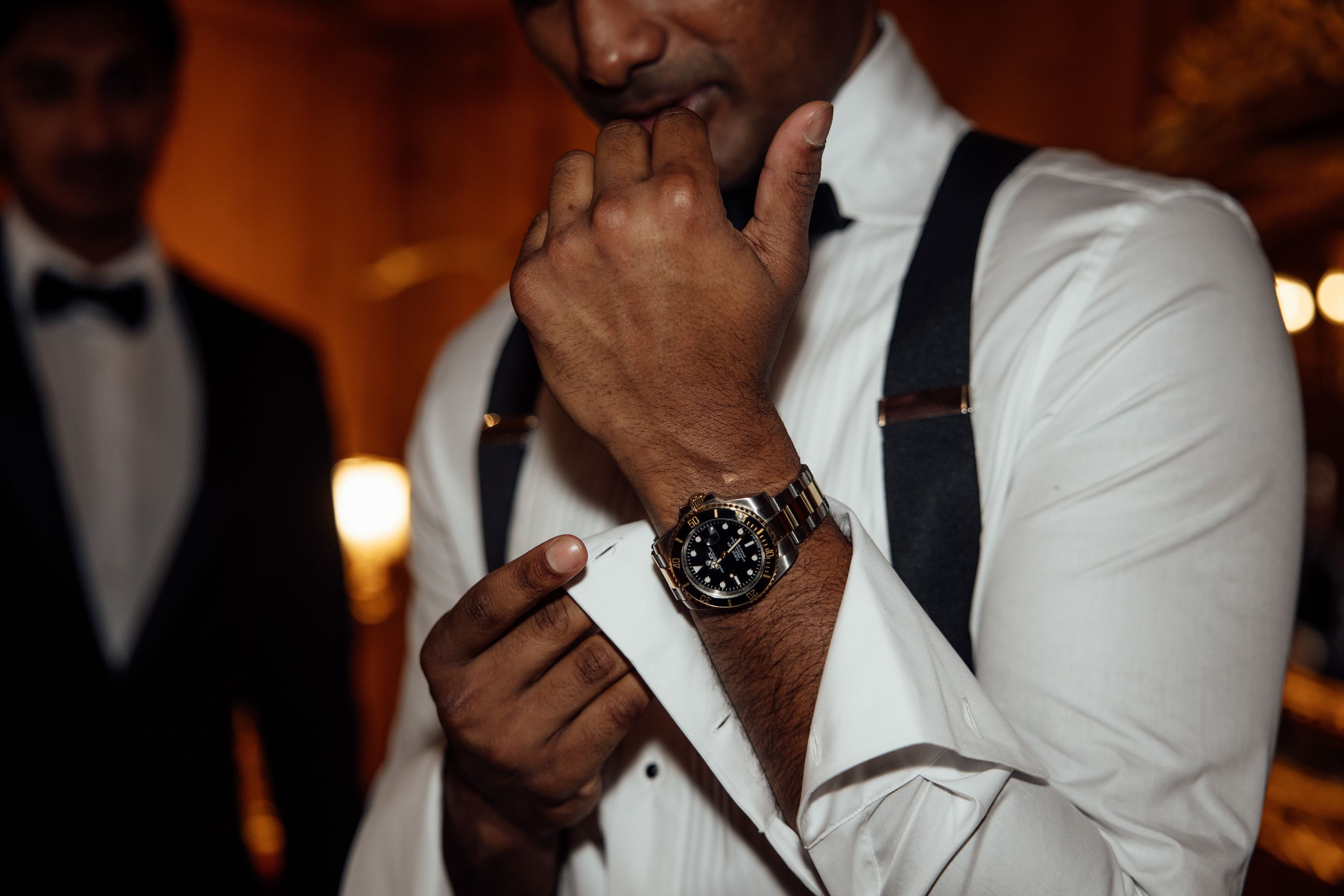 Groom adjusts his cuff while wearing a luxury watch ahead of a small wedding in Austria