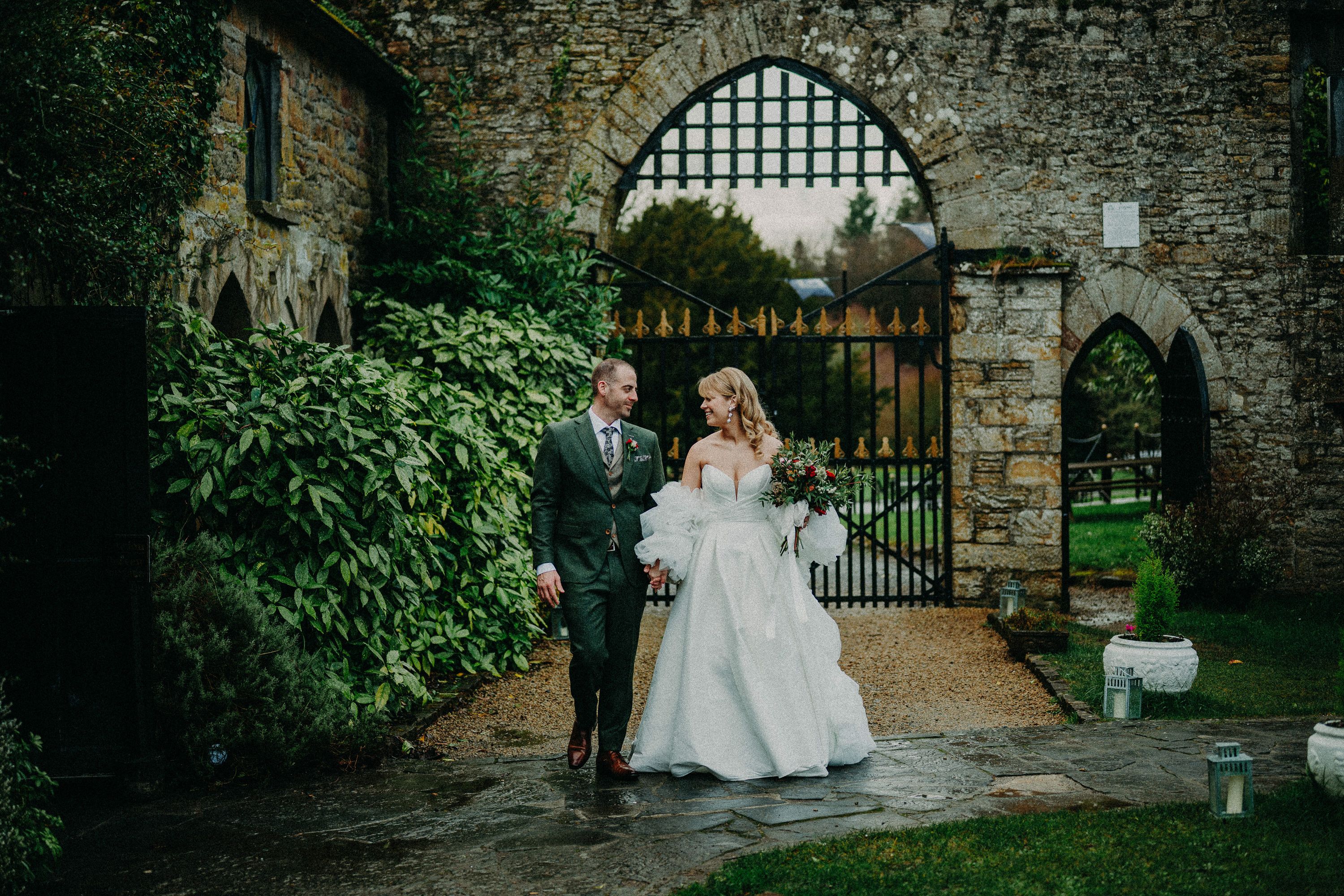 Bride and groom strolling through the castle gardens during a small wedding in Ireland