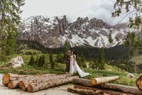 Bride and groom posing in front of the Alps at an elopement in Austria