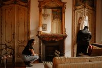 Our wedding planner in Italy looking at the groom as he inspects the bride's dress during when they eloped in Italy