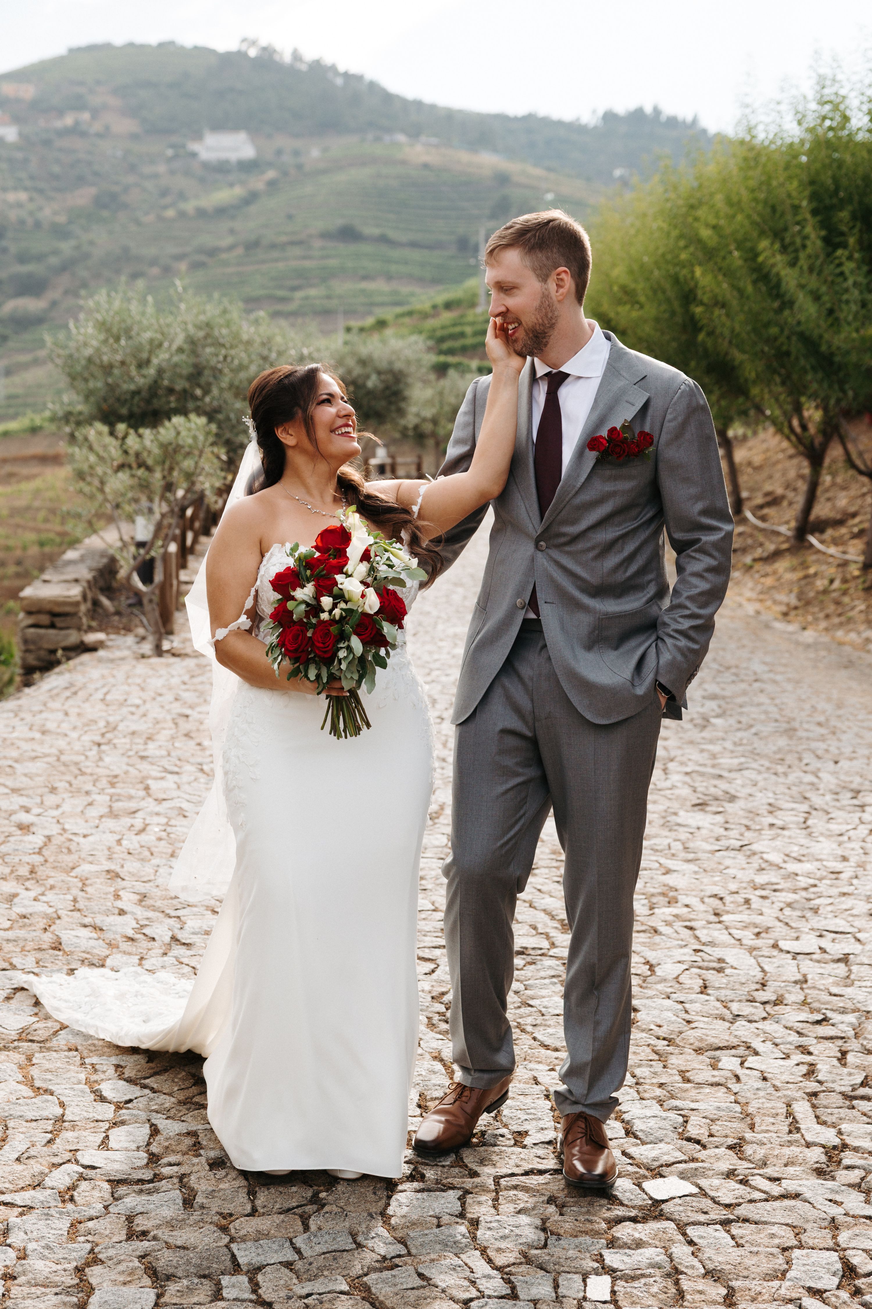 Bride and groom looking at each other while having an outdoor photoshoot during their destination wedding in Portugal