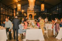 Wedding guests on the table during an evening reception of a destination wedding in Italy at Tuscany