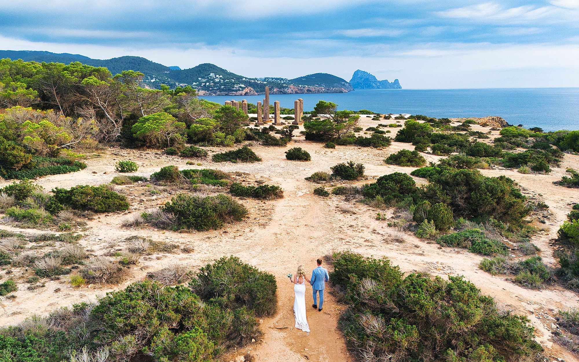 Sandy shores of Ibiza dotted by lush greenery with the Balearic sea on the edge