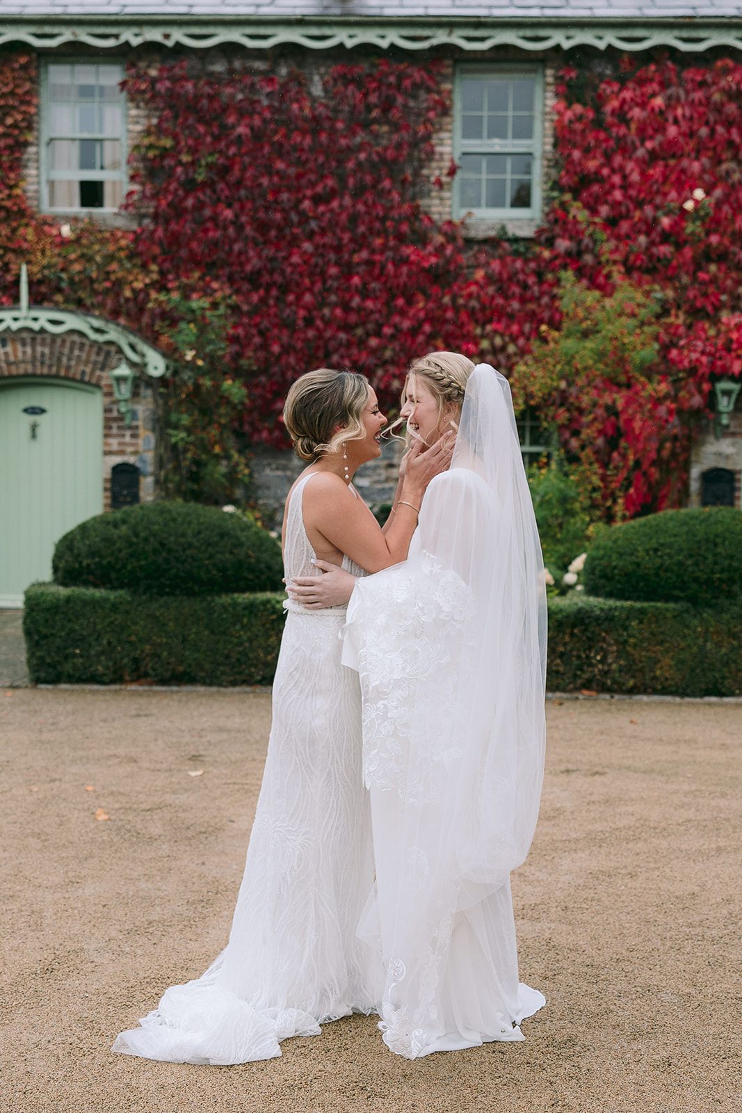Two brides holding each other during their first look for their small wedding in Ireland