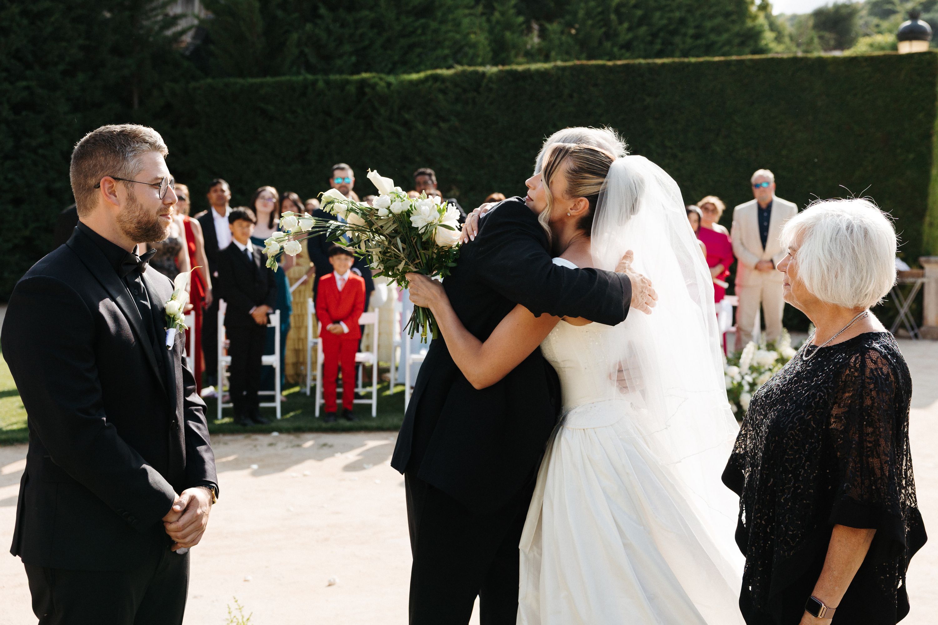 Bride sharing an emotional hug with a family member during an intimate wedding in Portugal ceremony
