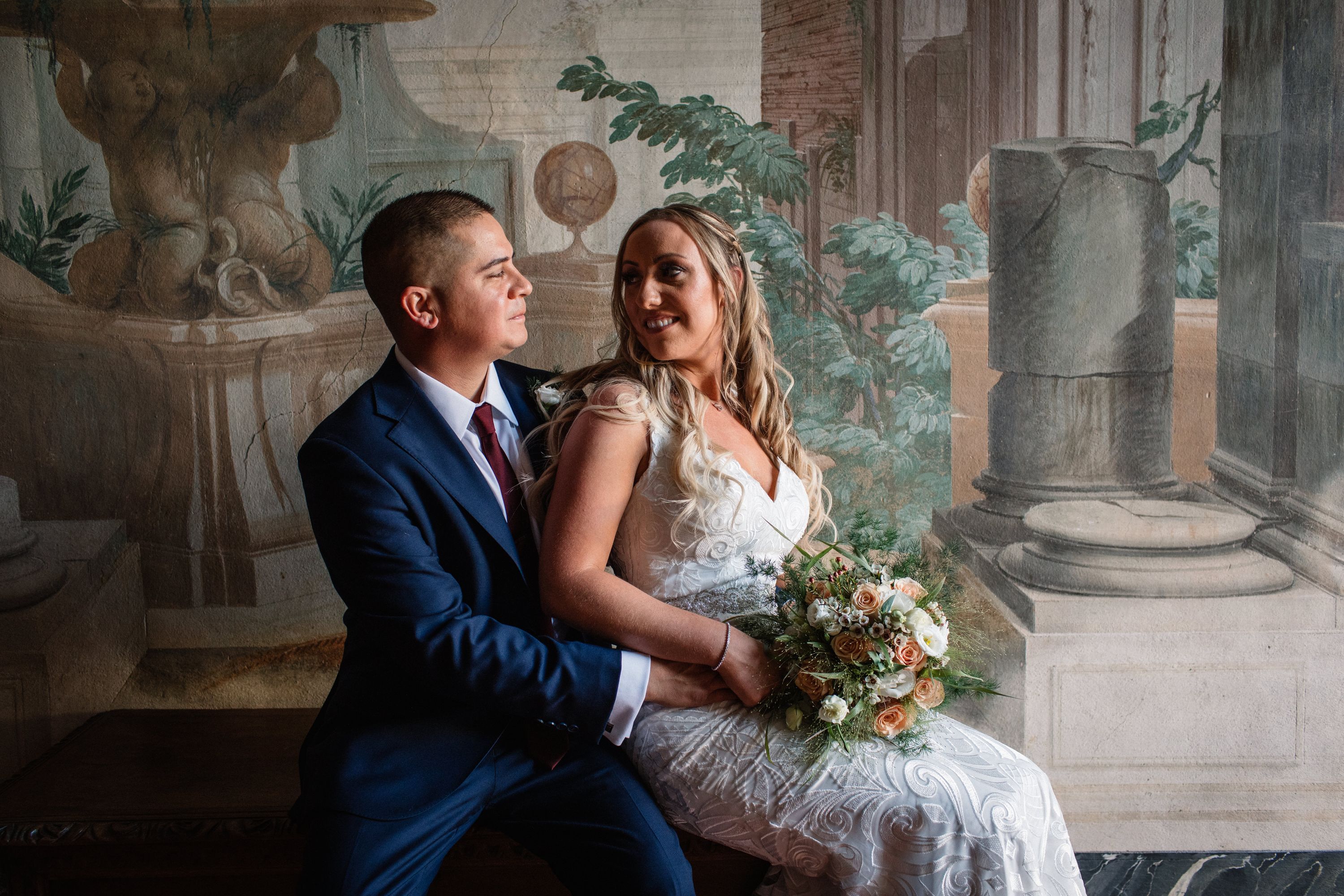 Bride and groom having a romantic indoor photoshoot in the Tuscan villa where they got married in Tuscany