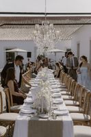 Guests arrive at the outdoor reception with a long table arranged for a micro wedding in Portugal