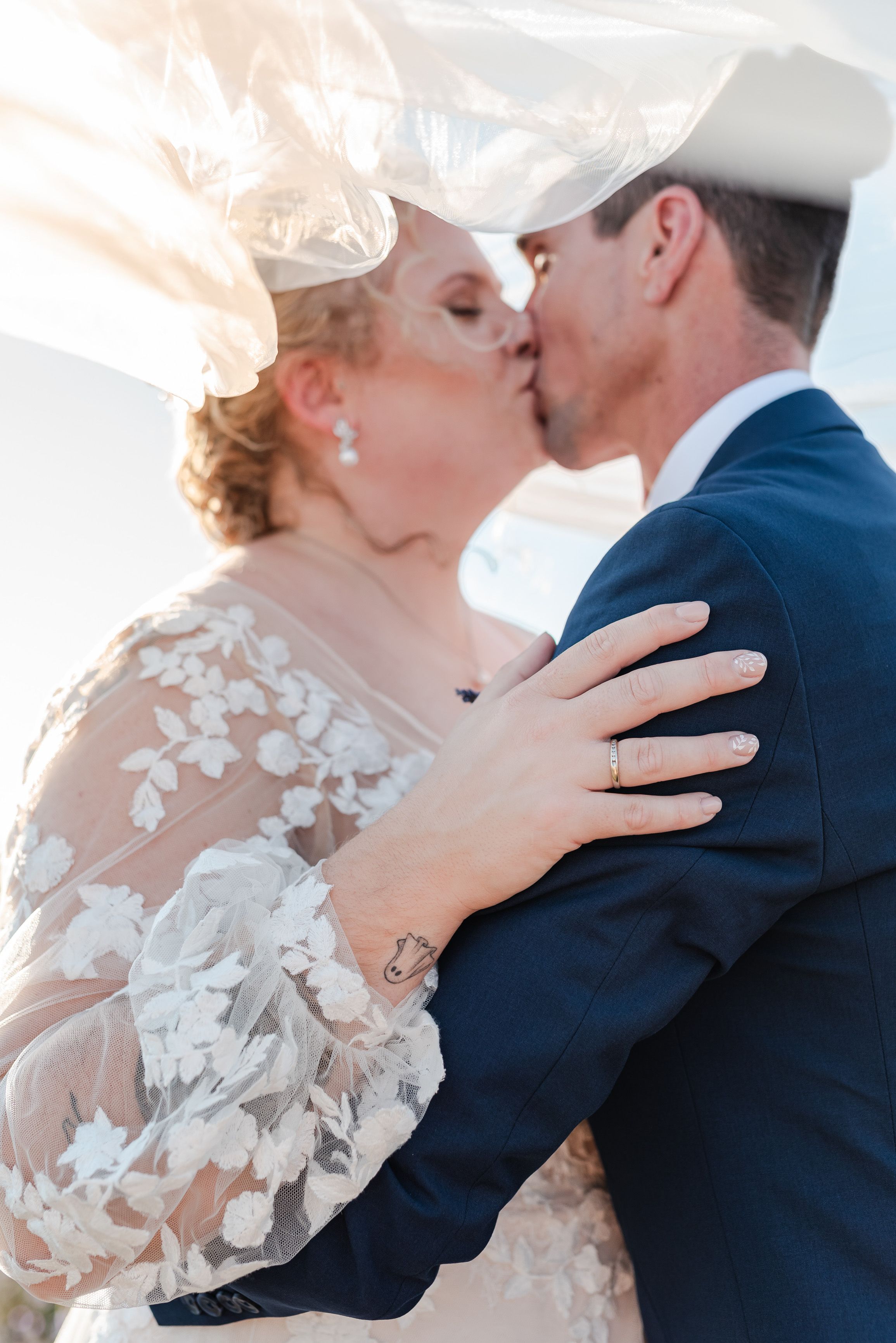 Close-up wedding portrait beneath a flowing veil at an intimate wedding in France