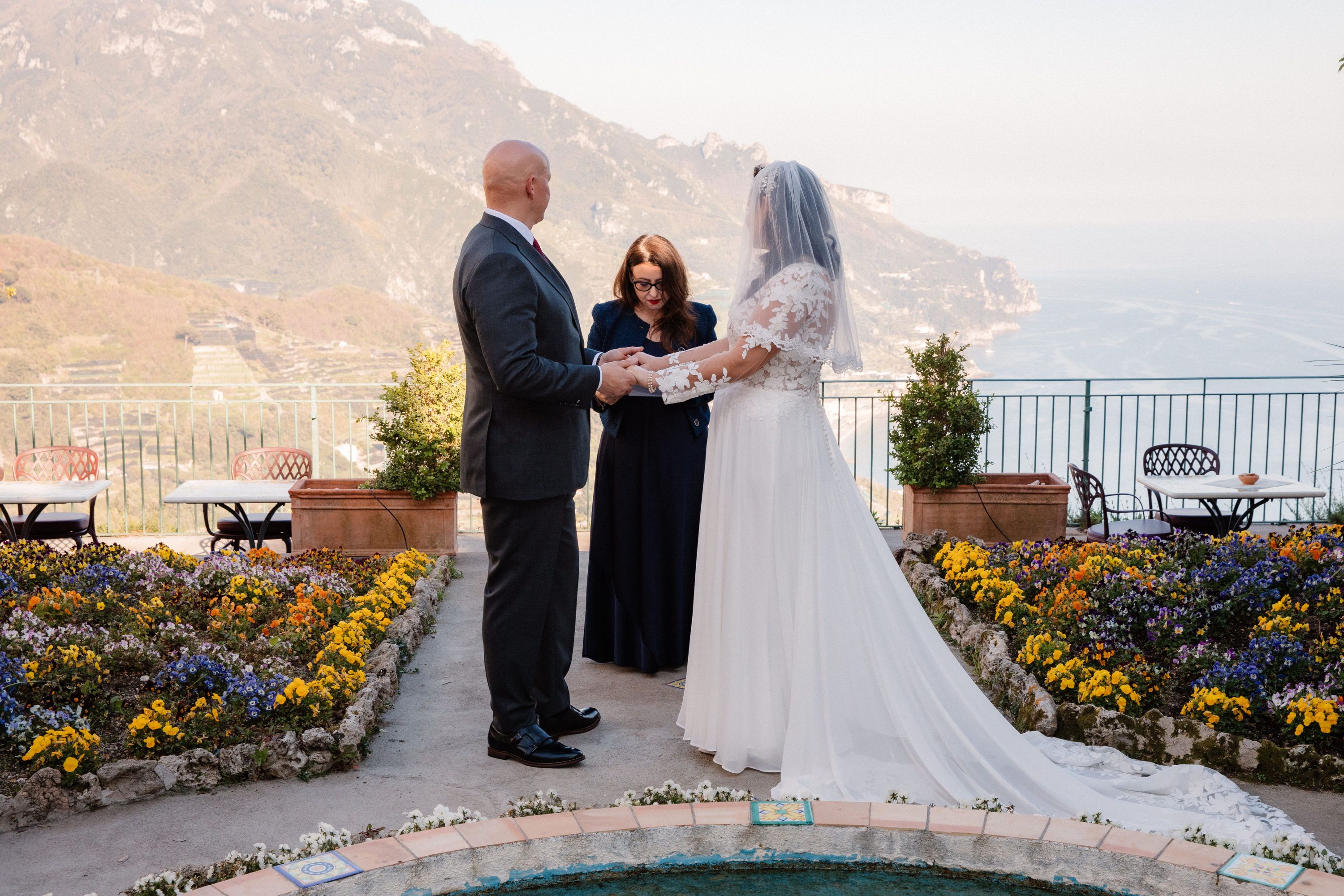 Couple holding hands during thir elopement ceremony in Italy
