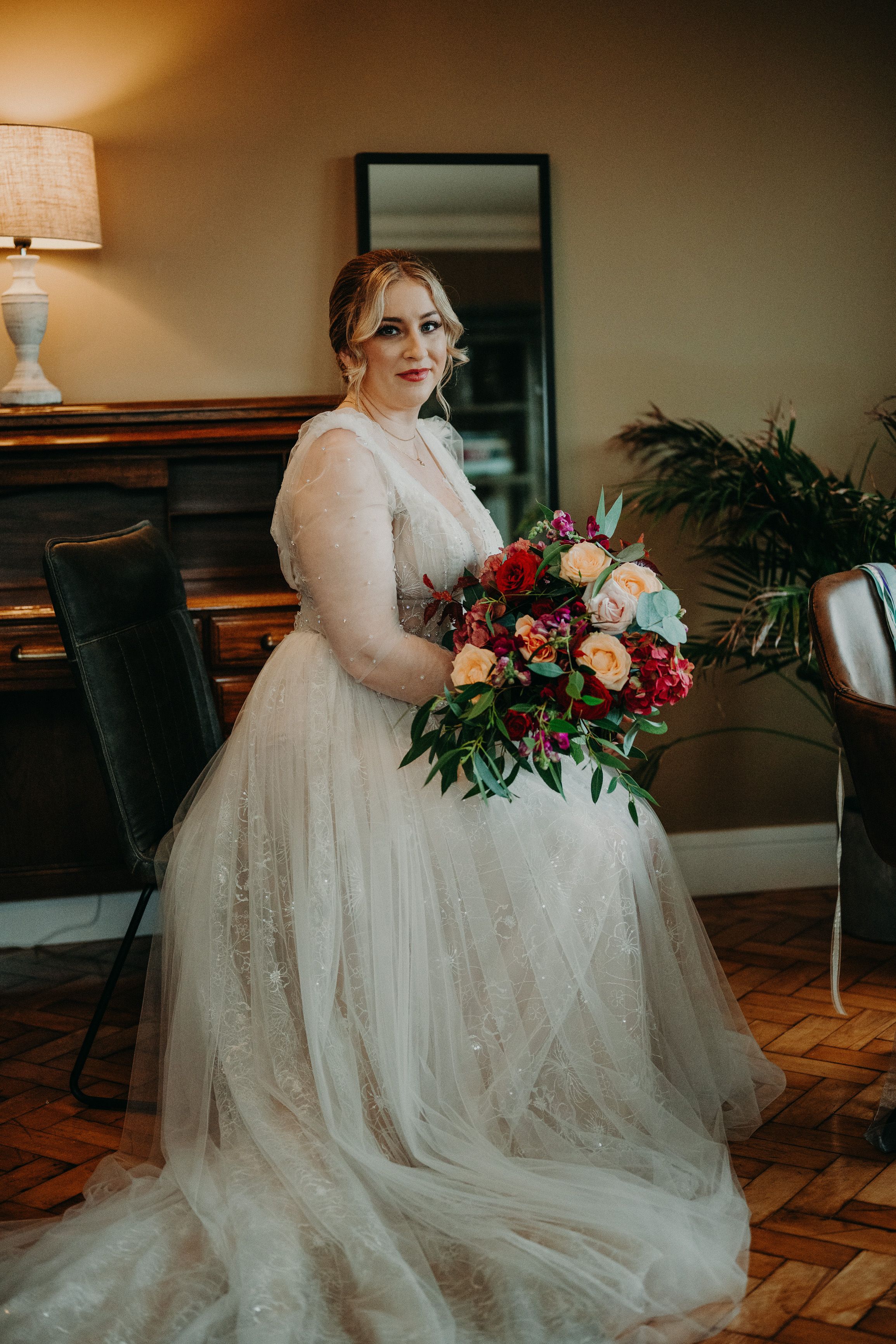 Bride holding a colorful bouquet during bridal preparations for a small wedding in Ireland