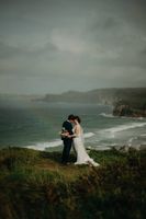 Bride and groom atop the cliffs of Antrim during their micro wedding in Ireland during autumn.