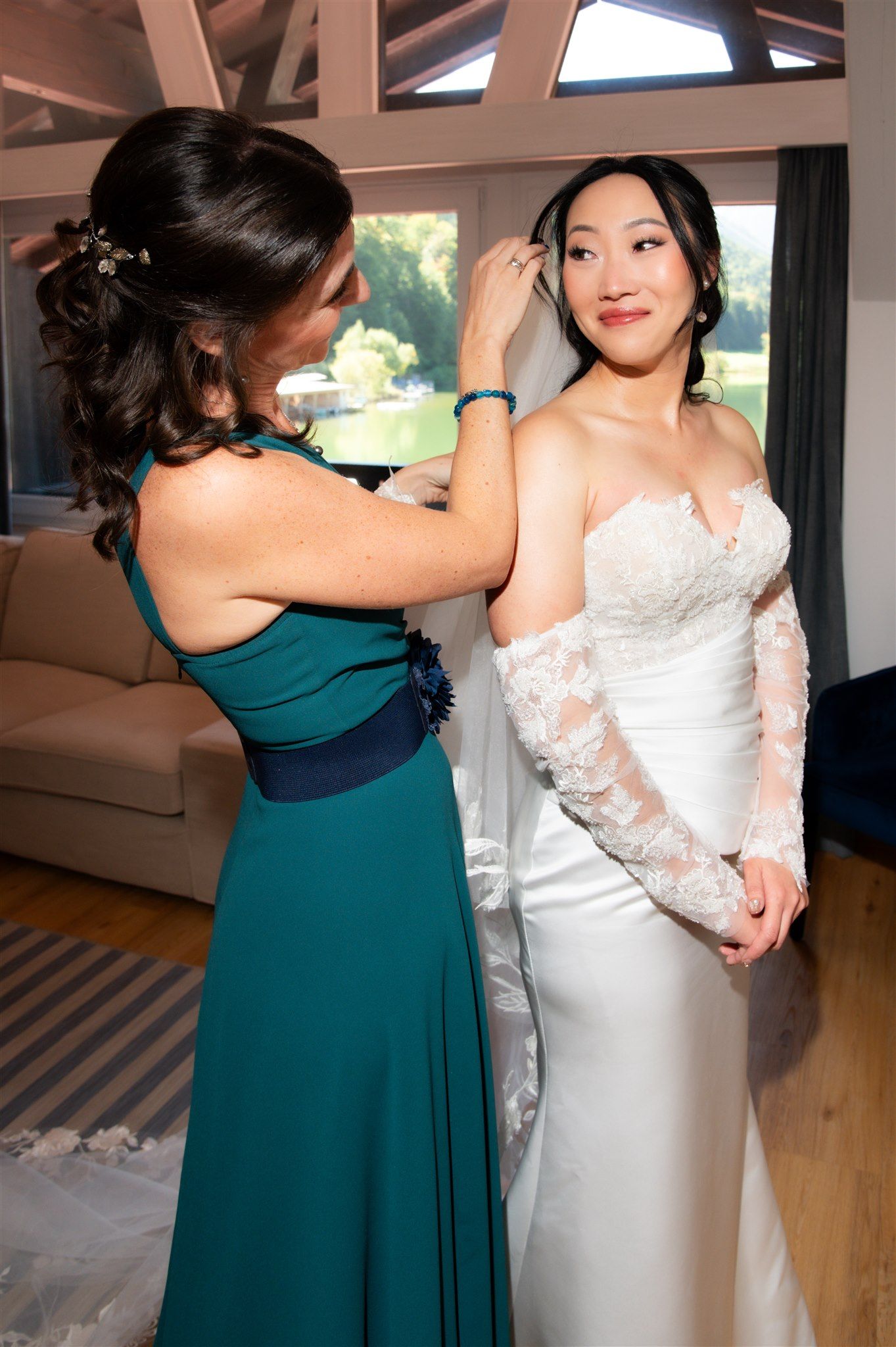 A bride preparing for her small wedding in Germany with her bridesmaid helping