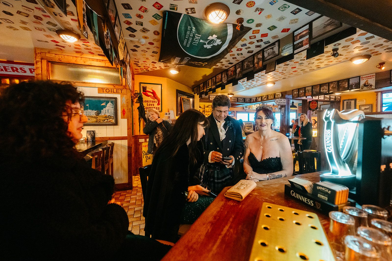 Newlyweds inside an Irish pub after the ceremony of their elopement in Ireland