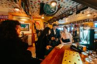 Newlyweds inside an Irish pub after the ceremony of their elopement in Ireland