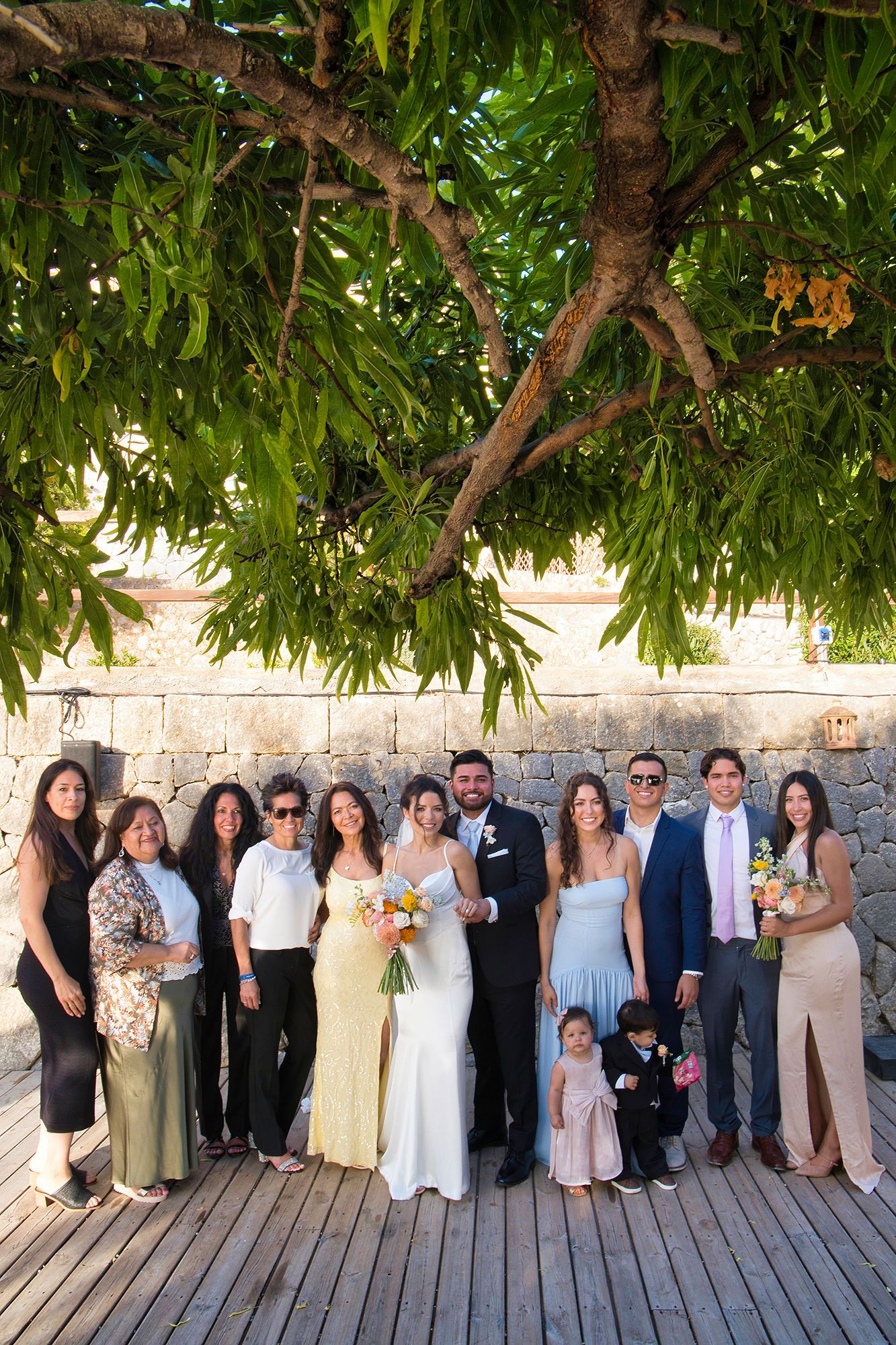 Bride and groom take portrait shots with their small group of guests during their intimate wedding in Spain
