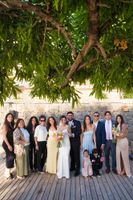 Bride and groom take portrait shots with their small group of guests during their intimate wedding in Spain