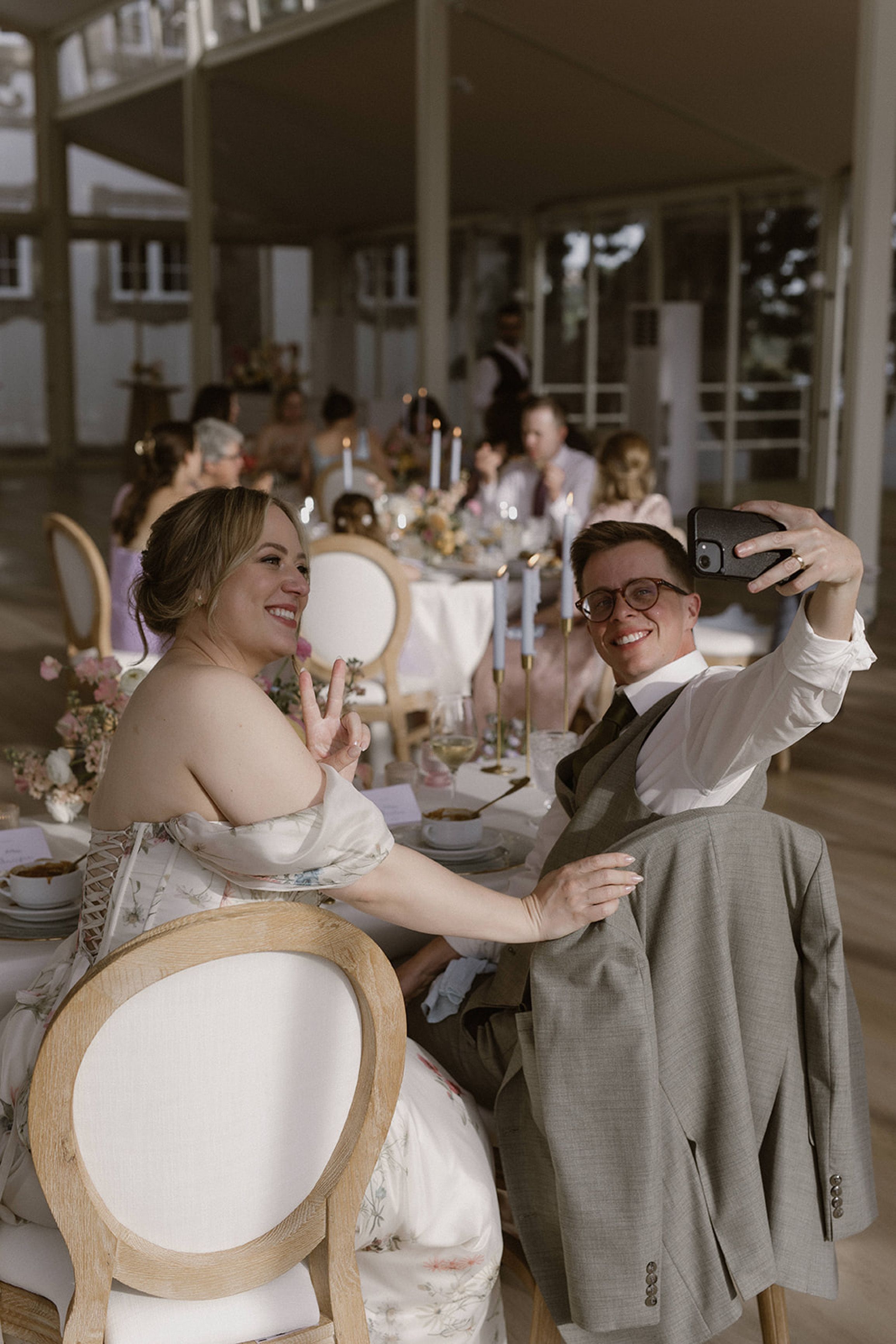 Newlyweds taking a joyful selfie during their reception at a small wedding in Portugal