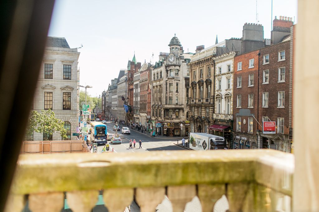 A view of Dublin city with its tall traditional buildings and a busy road