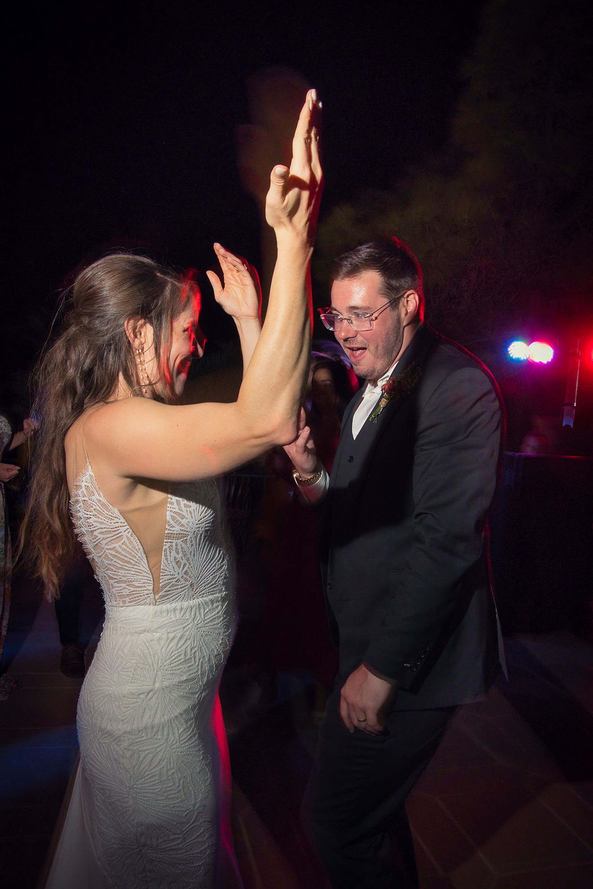Bride and groom dancing together during the evening reception at a small wedding in Europe