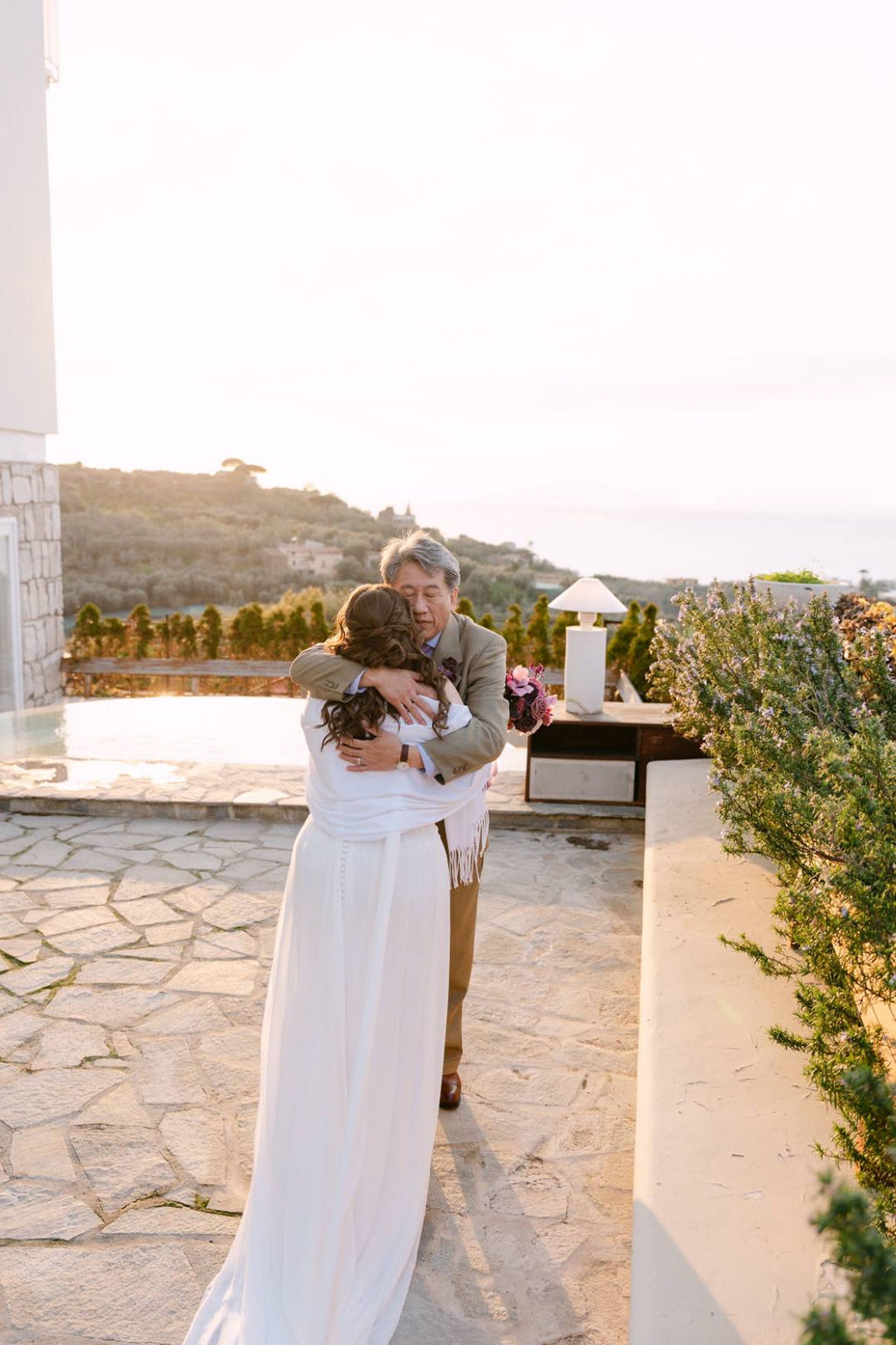 Newlyweds share an emotional embrace after their small wedding in Italy ceremony