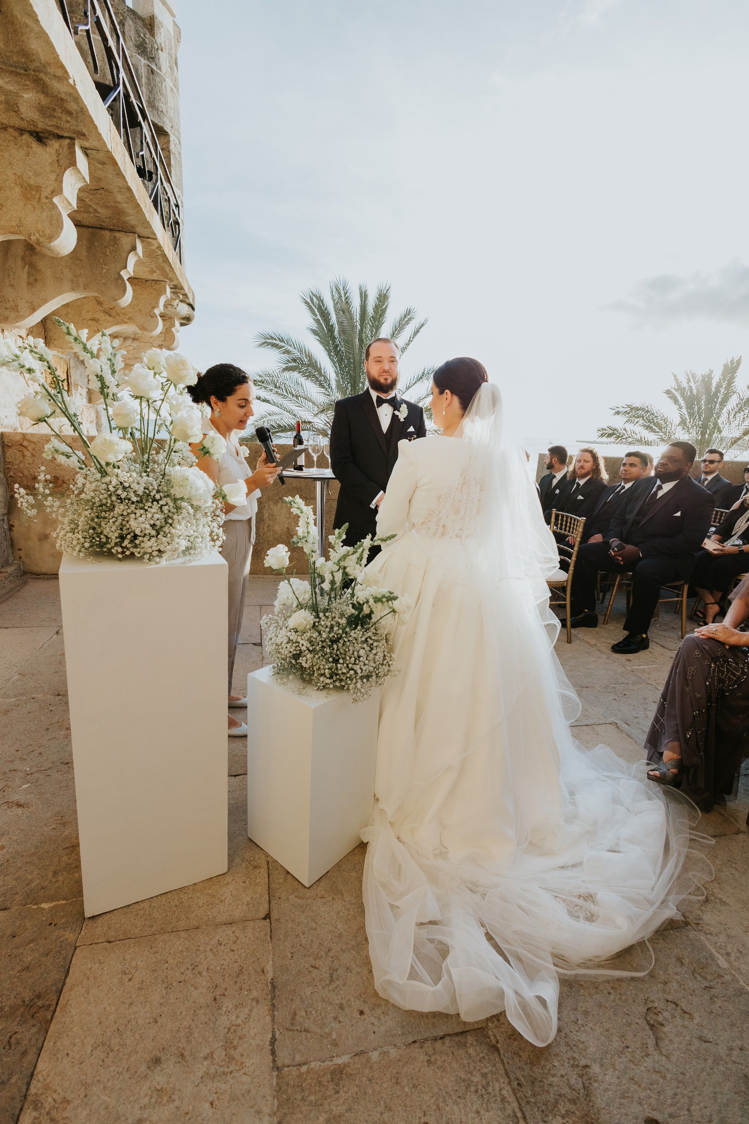 Bride and groom renew vows in portugal atop a terrace of a palace along the cascais coast