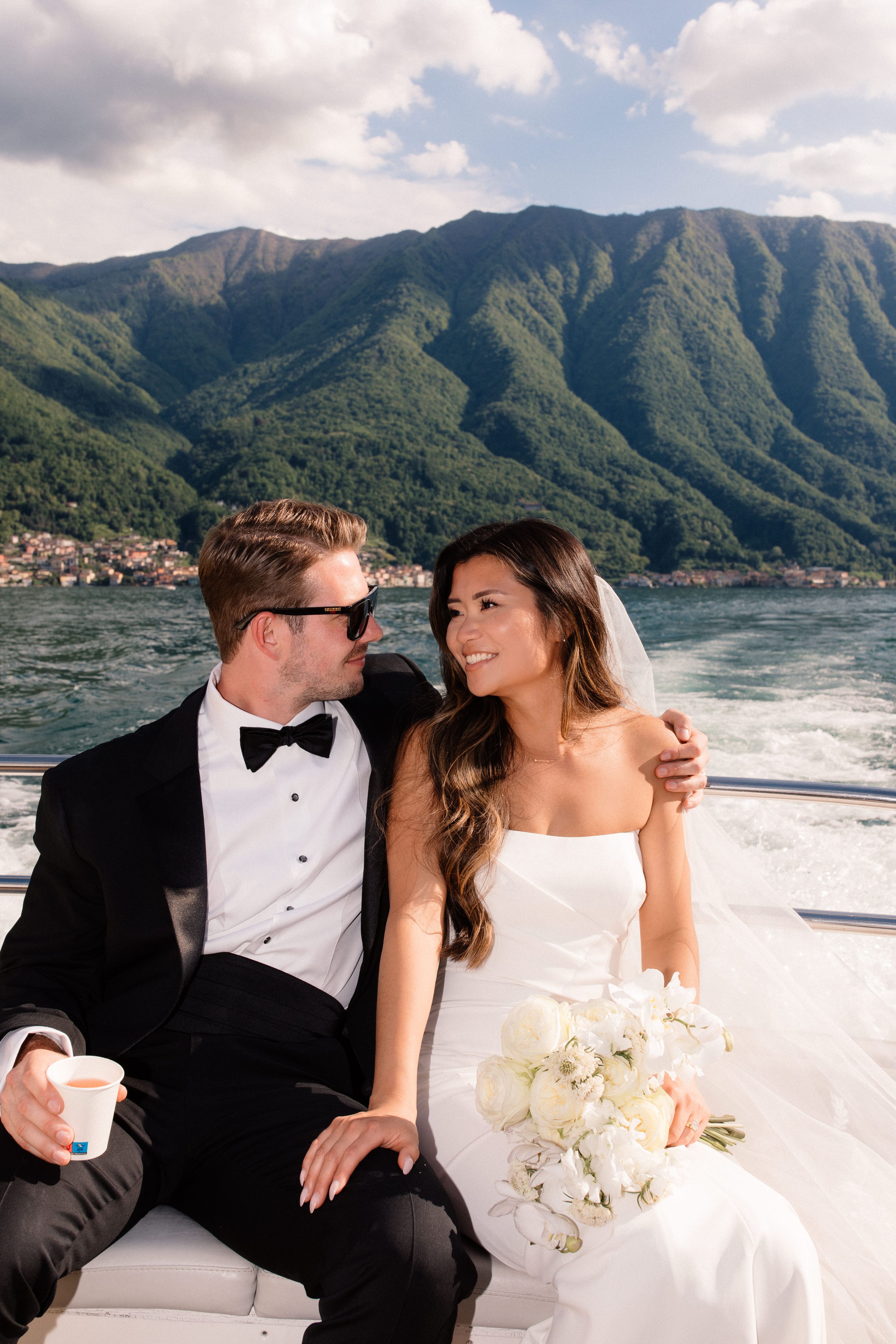 Bride and groom looking at each on a boat ride atop Lake Como for their elopement in Italy