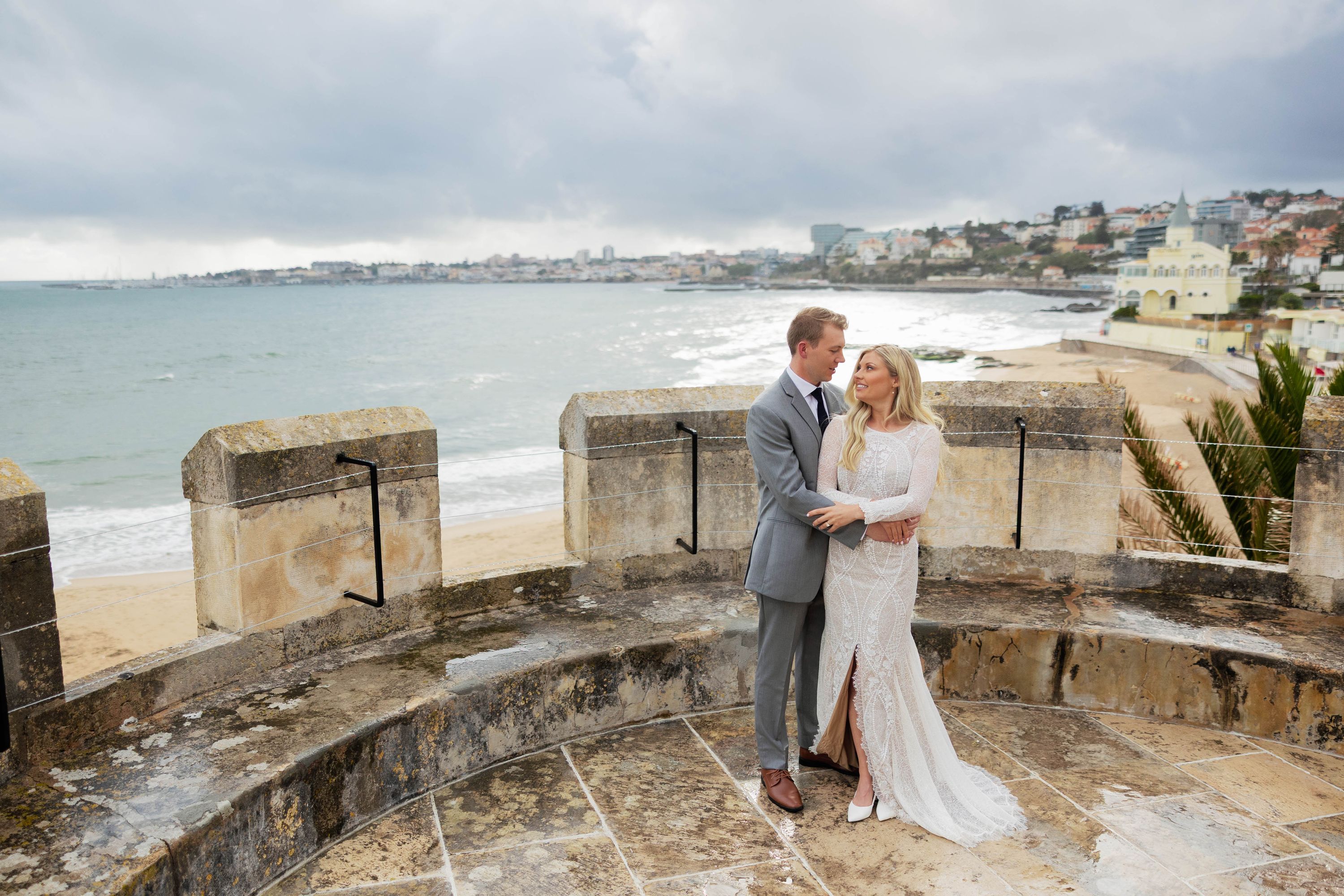 Bride and groom at the terrace of a seaside during their destination wedding in Portugal