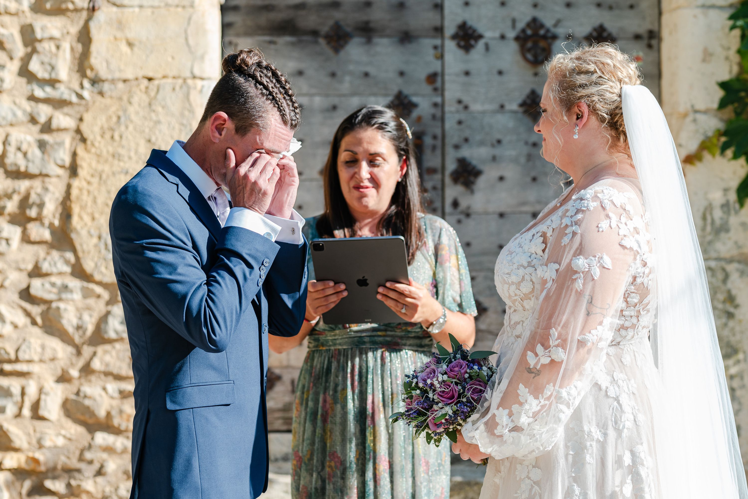 Emotional groom wiping away tears during a small wedding in France ceremony