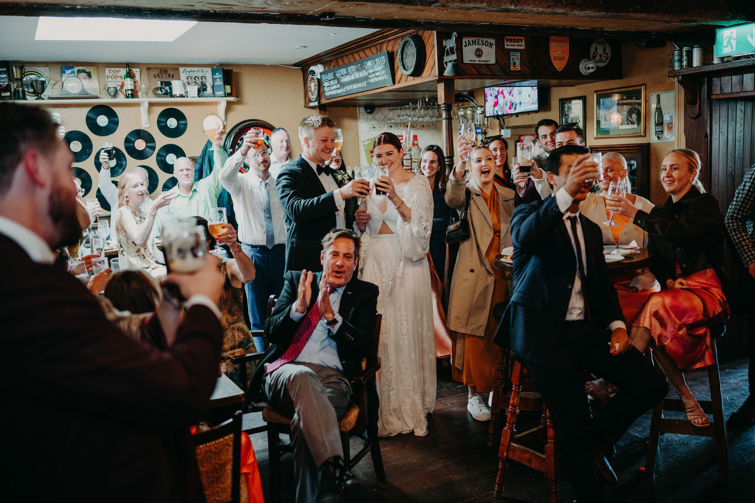 A bride and groom listening to a speech during a reception party after their intimate wedding in Ireland