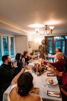 Groom standing and making a toast inside a dining hall during the reception of their elopement in Ireland