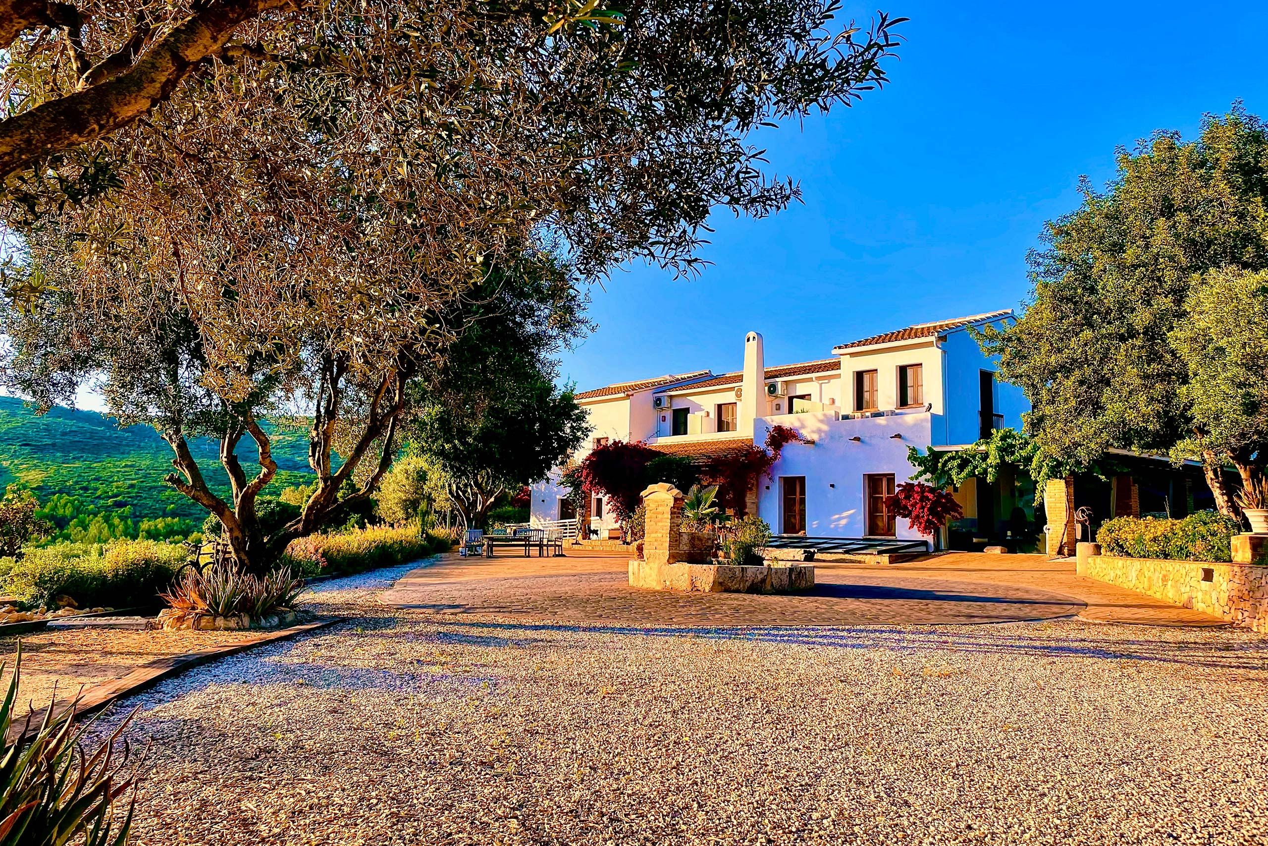 Minimalist white boutique hotel surrounded by trees for intimate weddings in Spain