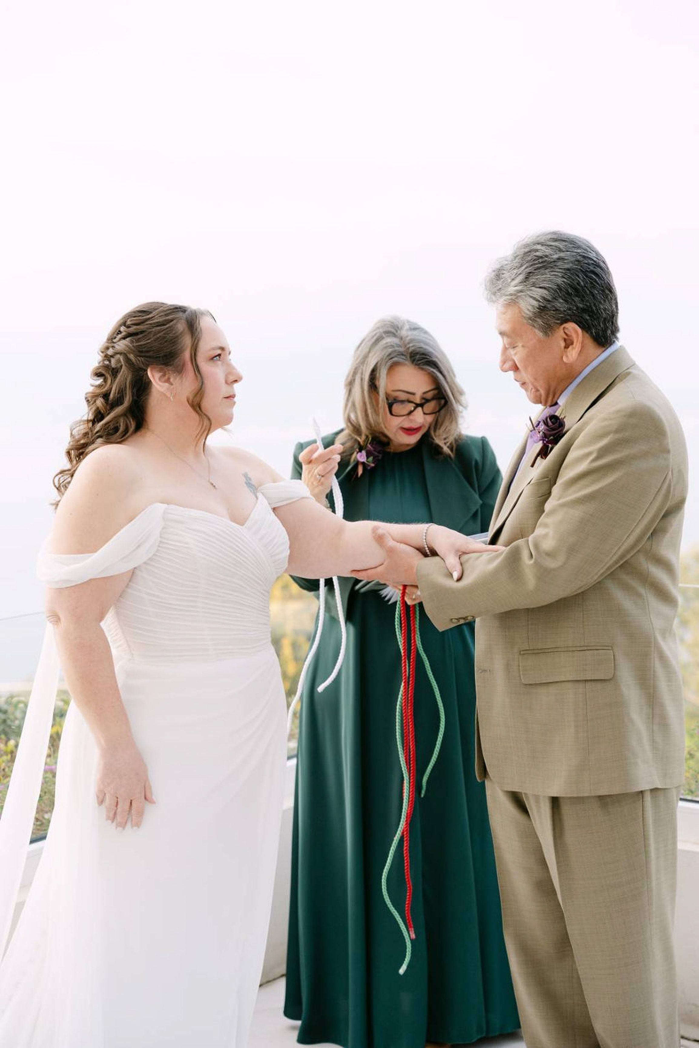 Handfasting ritual with colorful cords during an intimate wedding in Italy