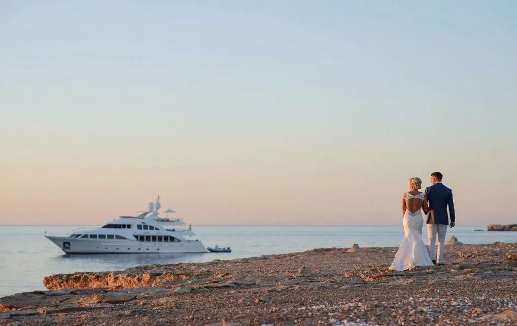 Bride and groom walking on a beach in Ibiza