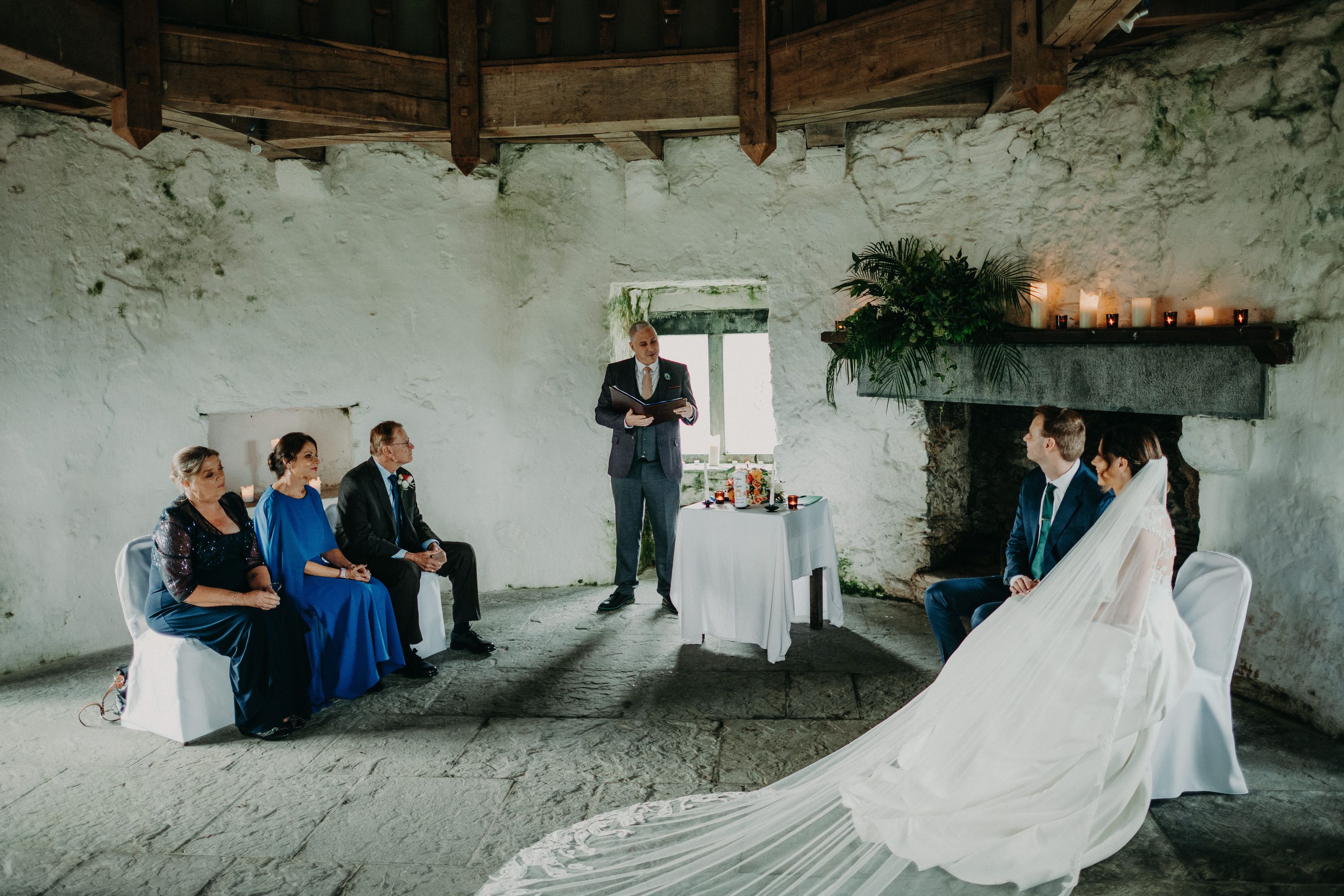 Couple seated together listening to wedding readings at an intimate wedding in Ireland.