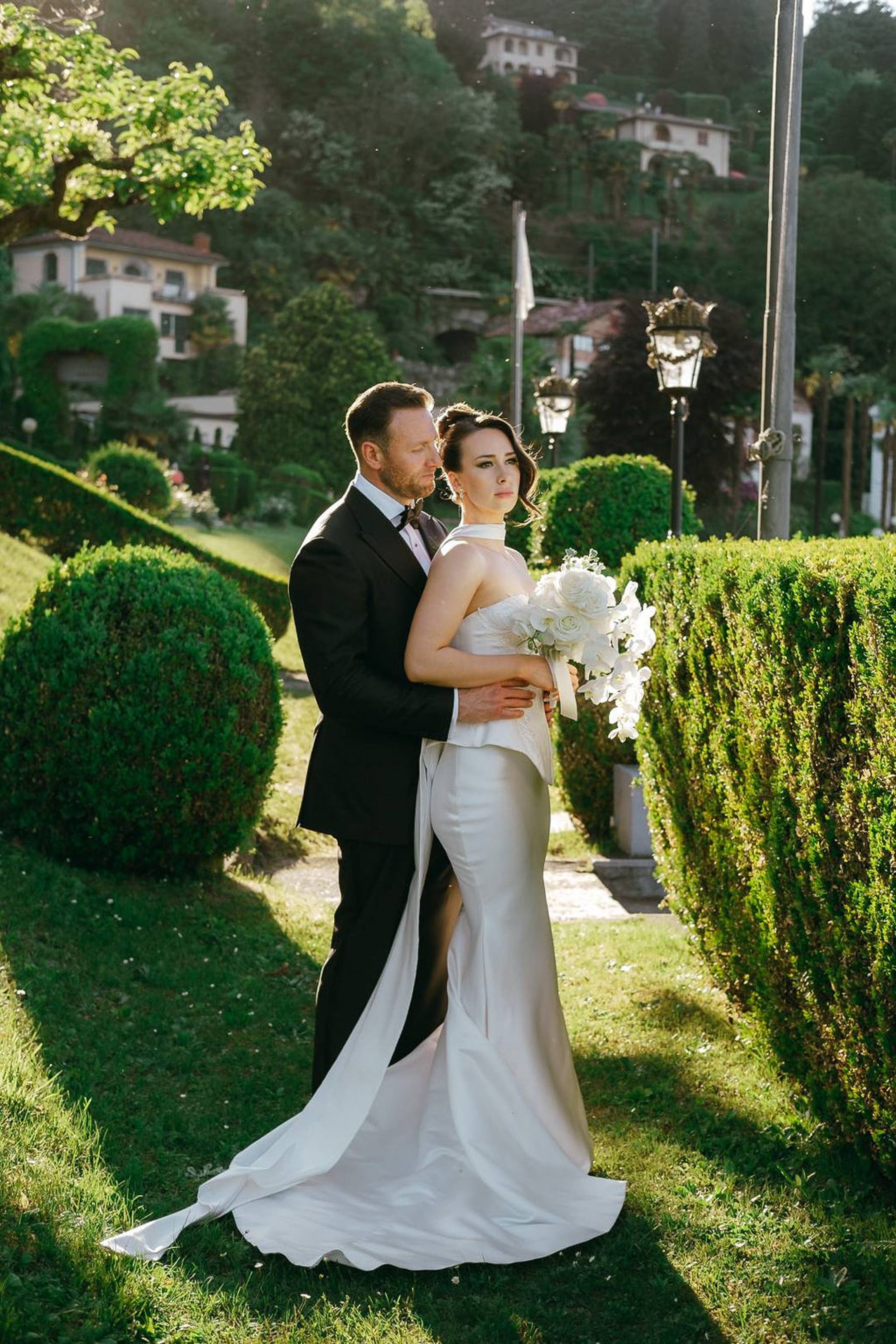 Elegant bride and groom portrait in a sunlit garden at an intimate wedding in Italy with a timeless aesthetic