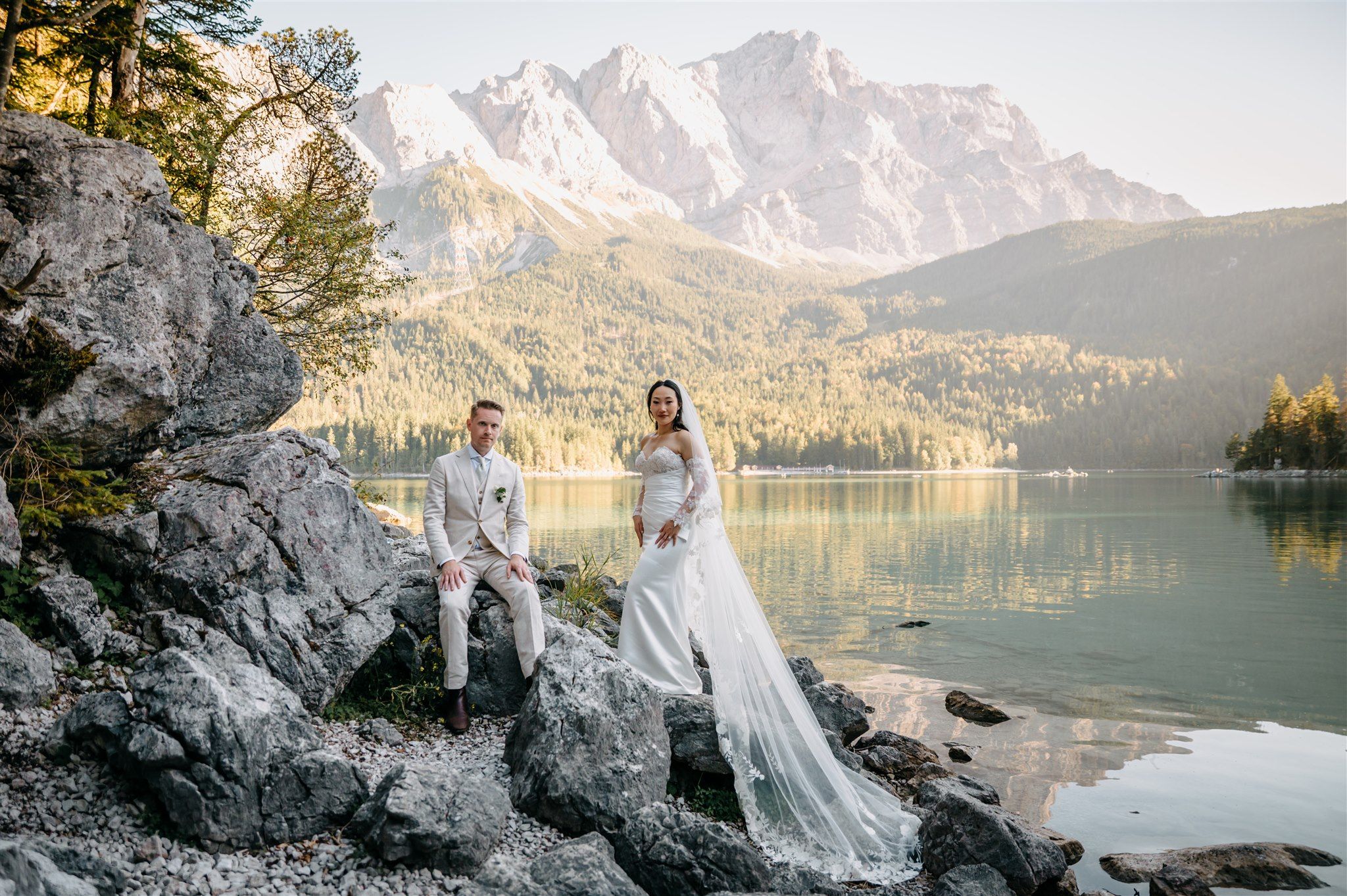 A bride and a groom for their small wedding in Germany set near a lake and a mountain