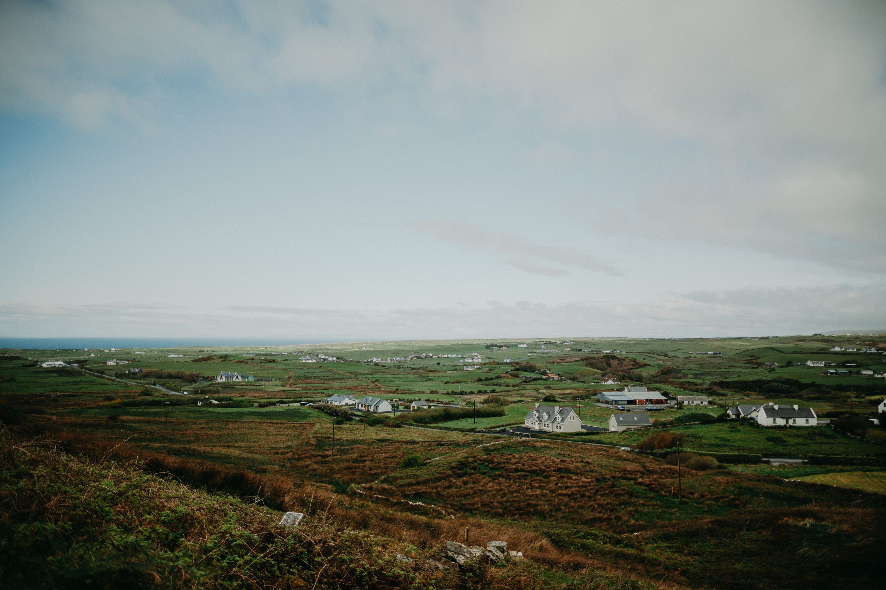 A whimsical village with open spaces and lush fields as a setting for a small wedding in Ireland