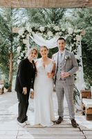 Wedding planner posing with bride and groom at a destination wedding in Portugal