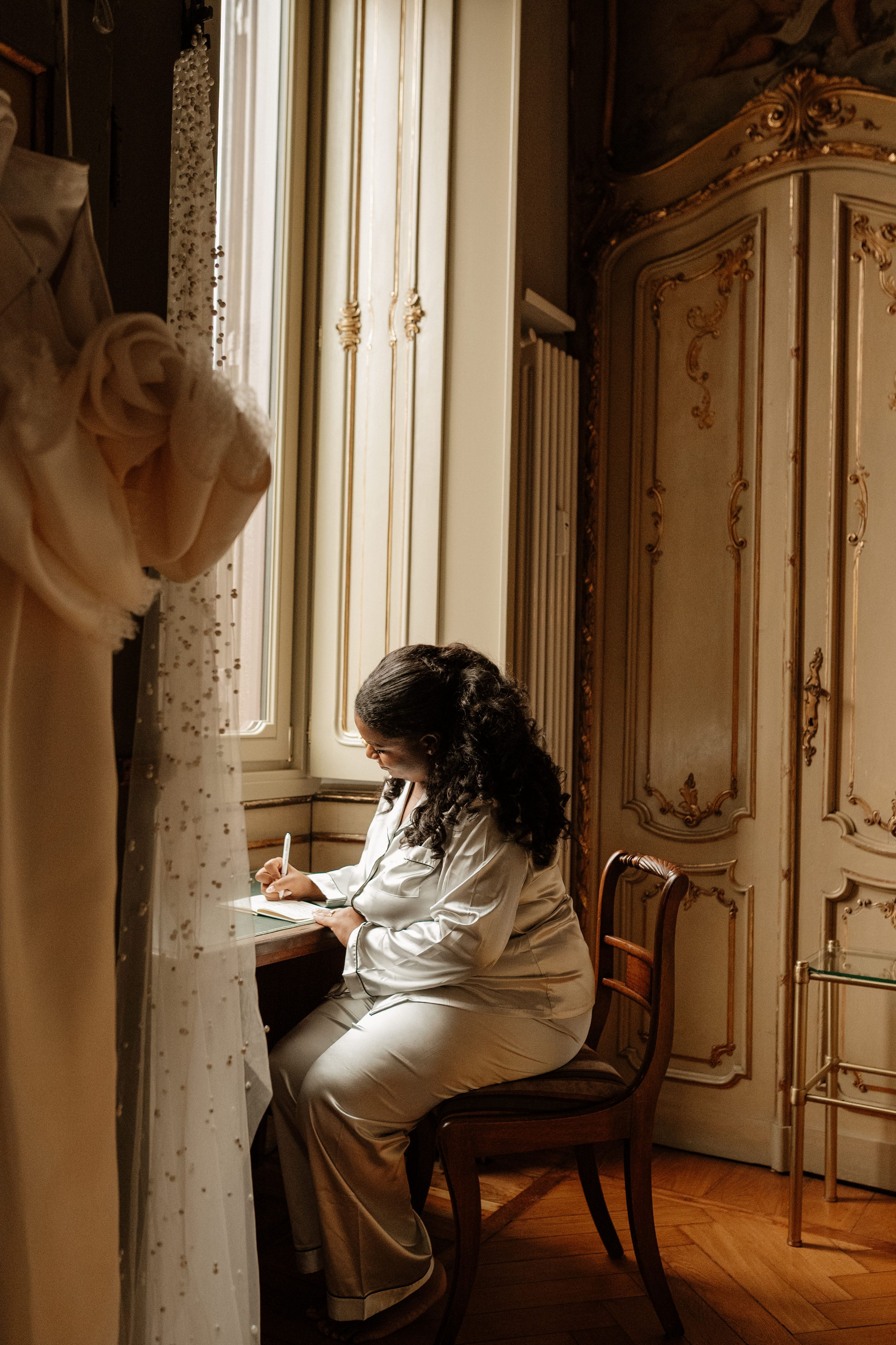 Bride writing her vows while getting ready for their Italian elopement in Turin