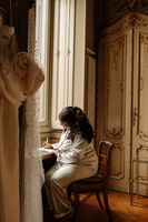 Bride writing her vows while getting ready for their Italian elopement in Turin