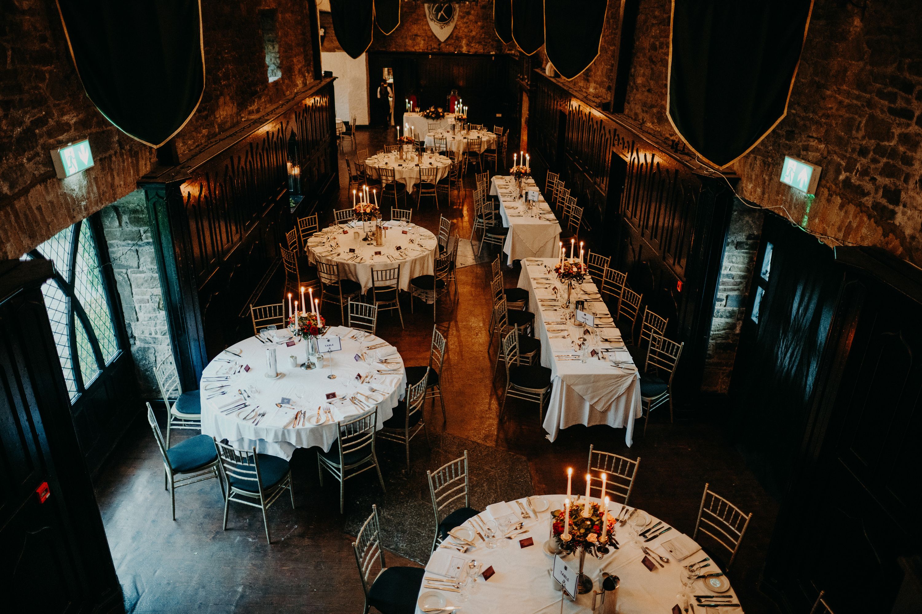 Elegant castle reception hall prepared for a small wedding in Ireland with candlelit tables