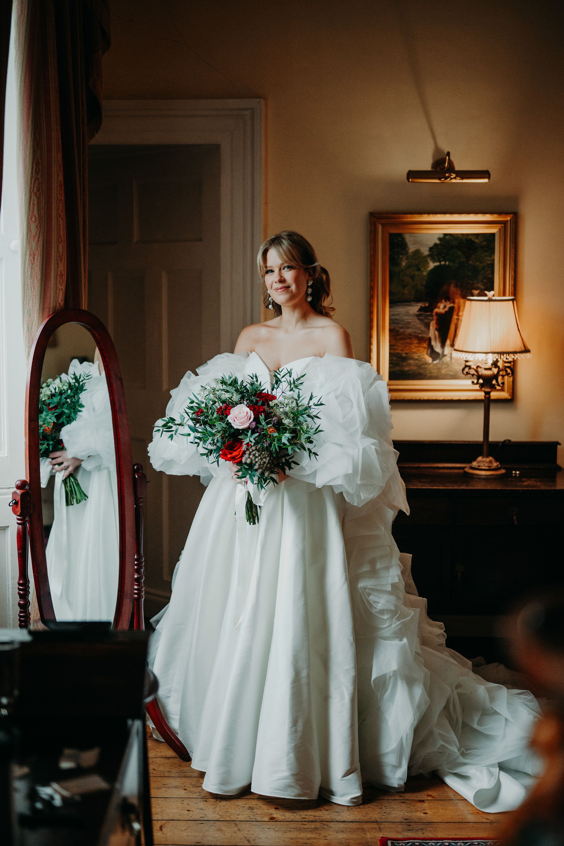 Bride holding a vibrant bouquet while getting ready for a small wedding in Ireland