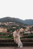 Newlyweds covered by the bride's veil during their small wedding in Italy at the heart of Amalfi