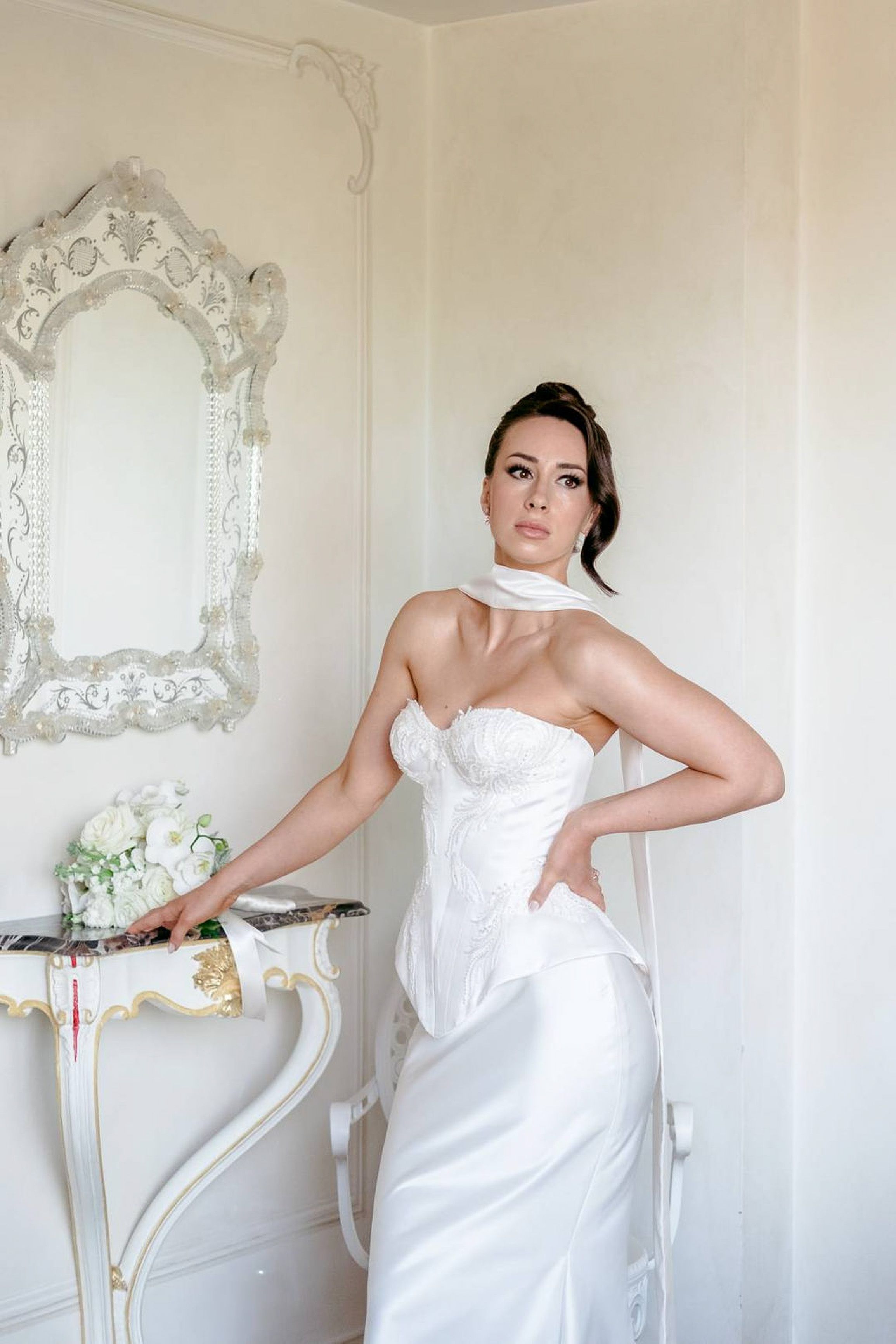Bride posing in a chic satin wedding gown inside a luxury villa during an intimate wedding in Italy