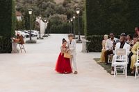 Little flower girl and her partner holding a basket while walking down the aisle during a destination wedding in Portugal