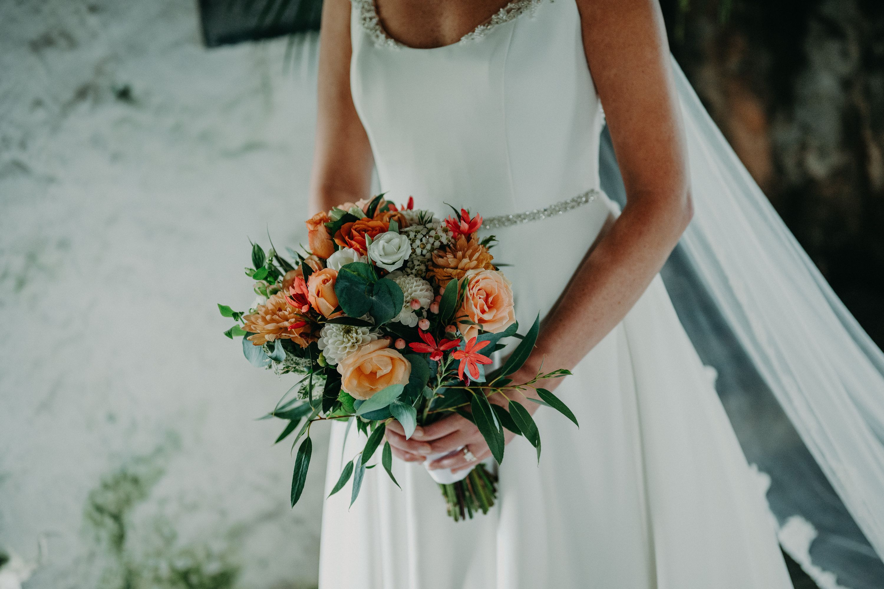 Close-up of a bridal bouquet with roses and greenery at a small wedding in Ireland.