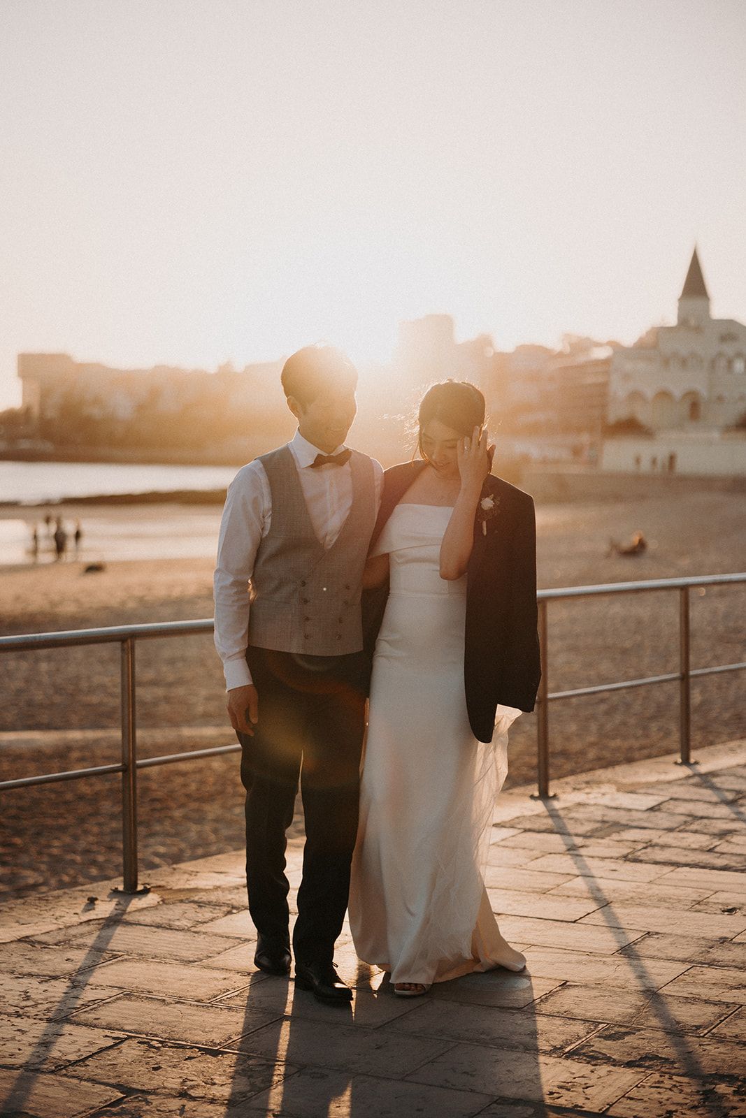 Newlyweds at the cemented area of the shore after the ceremony of their destination wedding in Portugal