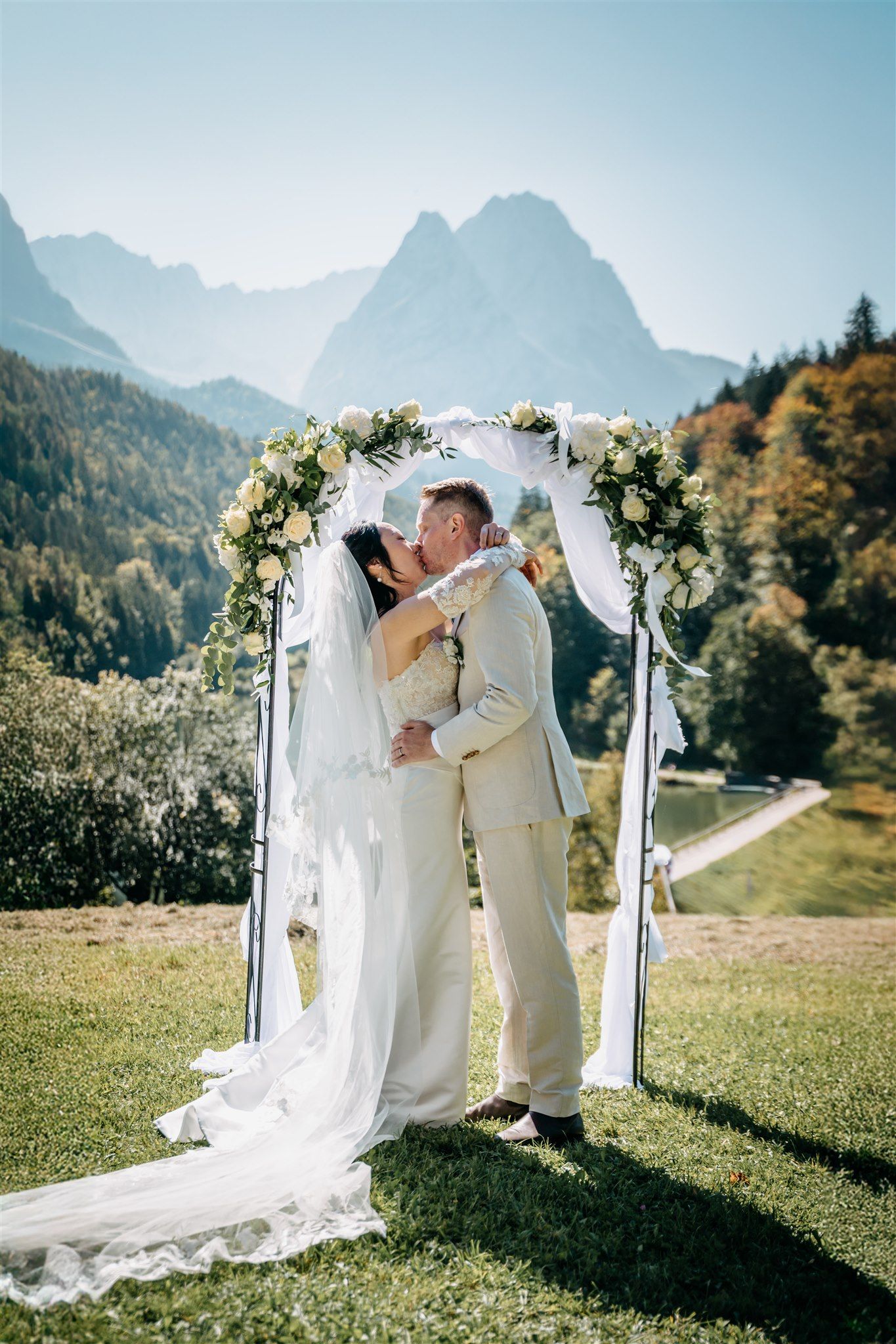 A bride and groom kiss at the conclusion of the ceremony of their small wedding in Germany